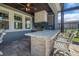 Outdoor kitchen has premium appliances, a countertop bar, and seating for entertaining at 14501 Wabasso Loop, Winter Garden, FL 34787