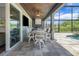 Covered outdoor area features a long table with chairs, an outdoor kitchen, and pool access at 14501 Wabasso Loop, Winter Garden, FL 34787