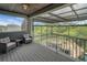This covered patio offers luxurious seating, a stone waterfall, and verdant, tree-lined views at 14501 Wabasso Loop, Winter Garden, FL 34787