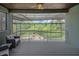 Relaxing covered patio with outdoor seating, wooden ceiling and view to the back at 14501 Wabasso Loop, Winter Garden, FL 34787