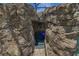 Grotto entrance to a pool with stone features and blue lighting at 14501 Wabasso Loop, Winter Garden, FL 34787