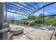 The enclosed pool has a custom rock waterfall with slide and lounge chairs at 14501 Wabasso Loop, Winter Garden, FL 34787