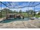 Lovely enclosed pool with rock waterfall, slide, and in-pool lounge chairs at 14501 Wabasso Loop, Winter Garden, FL 34787