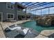 Amazing enclosed pool with waterfall, and ample seating with a bar area, and an upstairs balcony at 14501 Wabasso Loop, Winter Garden, FL 34787
