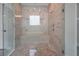 Beautiful walk-in shower with a mosaic tile floor, bench seat, and tiled walls at 14501 Wabasso Loop, Winter Garden, FL 34787
