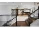A beautiful staircase with wood steps and iron railings leads to an open room with a pool table at 14501 Wabasso Loop, Winter Garden, FL 34787