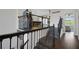 Elegant staircase with dark wood and decorative wrought iron spindles, accessing the upper level game room at 14501 Wabasso Loop, Winter Garden, FL 34787