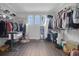 Spacious walk-in closet with built-in shelving and three windows for natural light at 14501 Wabasso Loop, Winter Garden, FL 34787