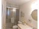 Clean bathroom featuring a shower with glass doors and a light countertop at 146 Hibiscus Way, Leesburg, FL 34748