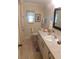 Cozy bathroom featuring tile flooring, neutral walls, and ample vanity space at 146 Hibiscus Way, Leesburg, FL 34748