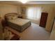 Comfortable bedroom with a queen-sized bed, dresser and soft carpet at 146 Hibiscus Way, Leesburg, FL 34748