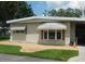 Charming home features decorative window shades and rock border landscaping at 146 Hibiscus Way, Leesburg, FL 34748
