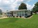 Well-maintained single-story home with covered parking, manicured lawn and lush landscaping at 146 Hibiscus Way, Leesburg, FL 34748