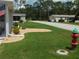 Well-manicured lawn and landscaping of a charming single story home in a quiet neighborhood at 146 Hibiscus Way, Leesburg, FL 34748