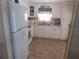 Bright and clean kitchen with white cabinets and appliances at 146 Hibiscus Way, Leesburg, FL 34748