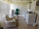 Bright laundry room with washer, dryer, seating and ample storage space at 146 Hibiscus Way, Leesburg, FL 34748