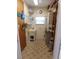 Clean laundry room featuring ample storage, utility sink, and tile flooring at 146 Hibiscus Way, Leesburg, FL 34748