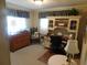 Home office includes wooden desk with shelving and drawers, side table, and natural light at 146 Hibiscus Way, Leesburg, FL 34748