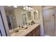 Bathroom vanity with and sink, mirror, and enclosed shower at 1550 Ward Ct, The Villages, FL 32162