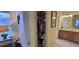 Bathroom featuring open walk-in closet, wooden cabinets, and vanity with a single sink at 1550 Ward Ct, The Villages, FL 32162