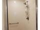 Enclosed shower featuring shower head and a grab bar at 1550 Ward Ct, The Villages, FL 32162