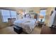 Comfortable bedroom with a plush bed, neutral tones, and great natural light at 1550 Ward Ct, The Villages, FL 32162