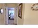 Shot of bedroom from hallway, featuring queen bed and bright light from windows at 1550 Ward Ct, The Villages, FL 32162