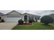 Charming home featuring manicured landscaping and a welcoming two-car garage at 1550 Ward Ct, The Villages, FL 32162