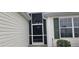 Screened front porch with storm door creates a welcoming entrance to the home at 1550 Ward Ct, The Villages, FL 32162