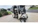 Enclosed golf cart with seating, windshield, and headlight package at 1550 Ward Ct, The Villages, FL 32162