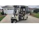 Enclosed golf cart with seating, windshield, and headlight package at 1550 Ward Ct, The Villages, FL 32162
