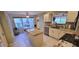 Inviting kitchen featuring an island, granite countertops, stainless appliances, and an adjacent breakfast nook at 1550 Ward Ct, The Villages, FL 32162
