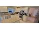 Bright kitchen with stainless appliances, granite countertops, and a spacious island at 1550 Ward Ct, The Villages, FL 32162