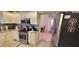 Well-equipped kitchen features stainless appliances, granite countertops, and opens to the dining area at 1550 Ward Ct, The Villages, FL 32162