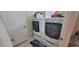 Convenient laundry room with modern washer and dryer, plus additional storage space at 1550 Ward Ct, The Villages, FL 32162