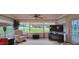 Inviting living room featuring neutral carpet, coffered ceilings, and large windows with nice outdoor view at 1550 Ward Ct, The Villages, FL 32162
