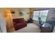 Cozy home office features a comfortable red chair, desk with computer and a bright window at 1550 Ward Ct, The Villages, FL 32162