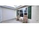 Cozy patio with two chairs and small table; perfect for relaxing outdoors at 1550 Ward Ct, The Villages, FL 32162
