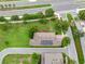 Aerial view of a well-maintained home featuring solar panels and expansive green lawn with manicured landscaping at 15531 Waterleigh Cove Dr, Winter Garden, FL 34787
