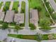 Aerial view of homes on manicured lawns, featuring paver driveway, landscaping and solar panels at 15531 Waterleigh Cove Dr, Winter Garden, FL 34787
