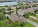 Aerial view of a neighborhood featuring well-maintained houses and a scenic lake at 15531 Waterleigh Cove Dr, Winter Garden, FL 34787