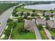 Aerial view of a beautiful home featuring lush green landscaping and solar panels near a tranquil lake at 15531 Waterleigh Cove Dr, Winter Garden, FL 34787