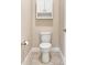 Small powder room featuring a toilet, cabinet, and paper towel holder at 15531 Waterleigh Cove Dr, Winter Garden, FL 34787