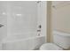 Bathroom featuring a white toilet, and combined bathtub and shower with white tile at 15531 Waterleigh Cove Dr, Winter Garden, FL 34787