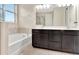 Elegant primary bathroom with double vanity, soaking tub, and glass-enclosed shower for a spa-like experience at 15531 Waterleigh Cove Dr, Winter Garden, FL 34787