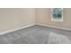 Bright, neutral bedroom with gray carpeting and a window providing natural light and outdoor views at 15531 Waterleigh Cove Dr, Winter Garden, FL 34787