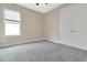 Bedroom with gray carpeting, neutral walls, a window and closet space with double doors at 15531 Waterleigh Cove Dr, Winter Garden, FL 34787