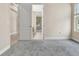 Bedroom with neutral walls, gray carpet and a view into another room via the doorway at 15531 Waterleigh Cove Dr, Winter Garden, FL 34787