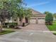 Beautiful home featuring a two-car garage, paver driveway, and meticulously landscaped front yard at 15531 Waterleigh Cove Dr, Winter Garden, FL 34787