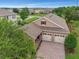 Aerial view of a well-kept home with a paver driveway, two-car garage, and lush landscaping at 15531 Waterleigh Cove Dr, Winter Garden, FL 34787